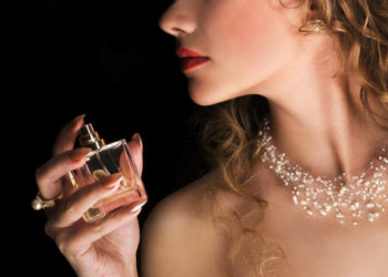 Parfemi koji mirišu na tihi luksuz a nisu preskupi; žena uživa u luksuznom parfemu